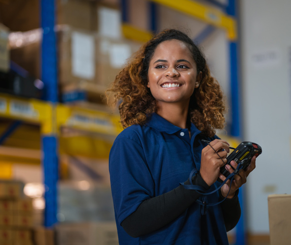 industrial worker woman smiling in warehouse, stock checking